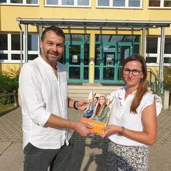Angebotsübersicht für Schulen © Pressestelle Burgenlandkreis Amtsleiter Robert Brückner übergibt Frau Fischer-Weißenfels, Schulleiterin der Pestalozzischule Naumburg, eine Angebotsübersicht.